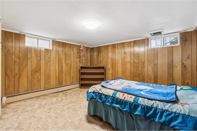 carpeted bedroom with baseboard heating and wood walls