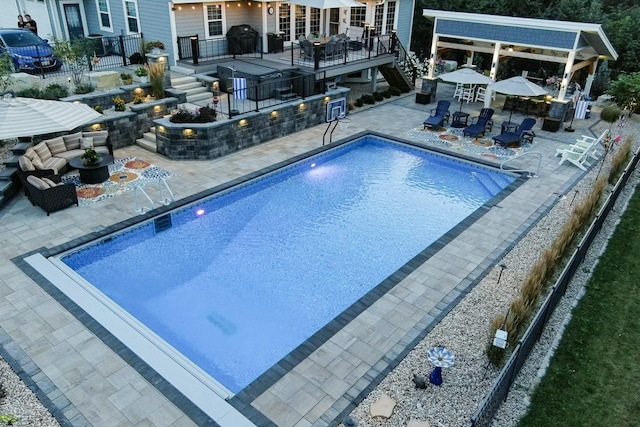 view of swimming pool with a grill, a patio area, and an outdoor bar