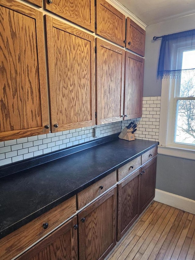 kitchen with light hardwood / wood-style flooring and tasteful backsplash