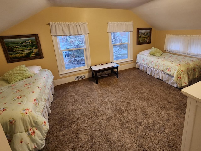 carpeted bedroom with lofted ceiling