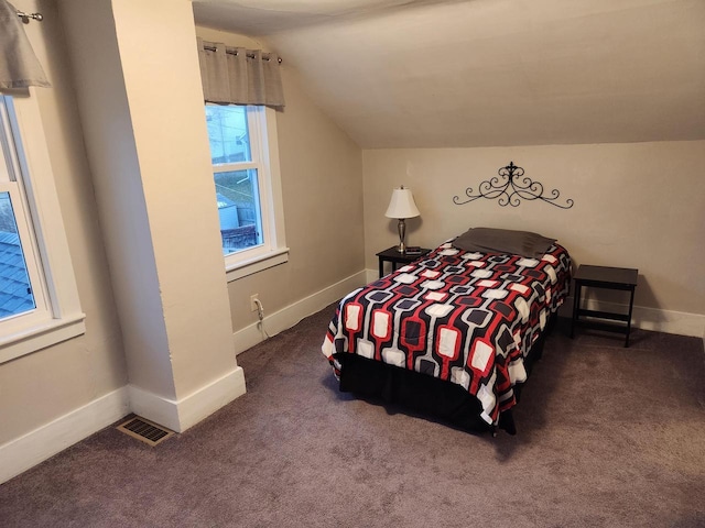 bedroom with vaulted ceiling and carpet