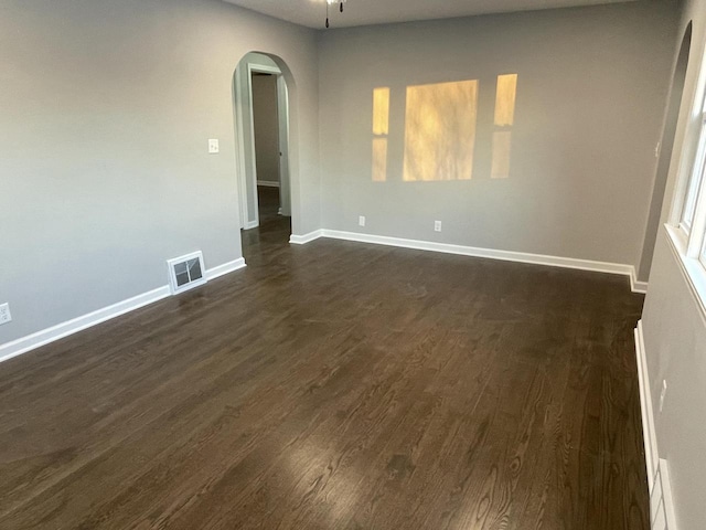 spare room featuring ceiling fan and dark hardwood / wood-style floors