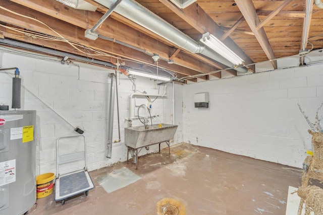 basement featuring water heater and sink