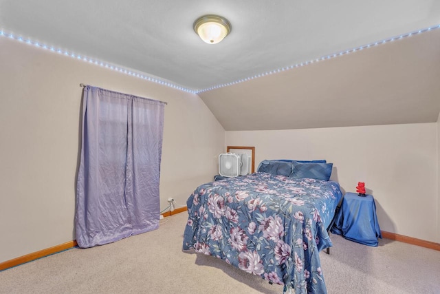 bedroom with light colored carpet and lofted ceiling