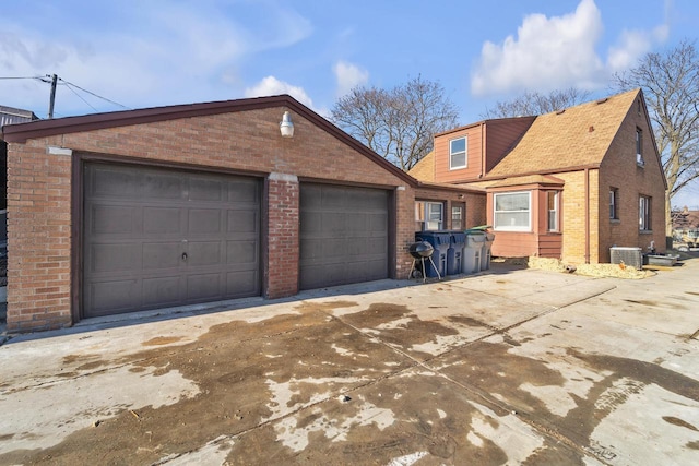 view of front of home featuring central AC unit and a garage