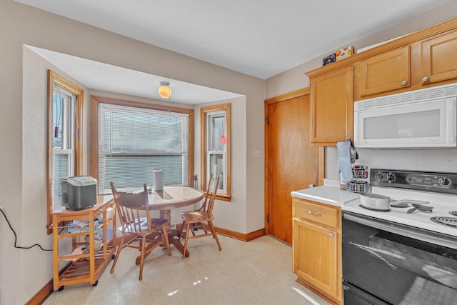 kitchen with range with electric stovetop and light brown cabinets