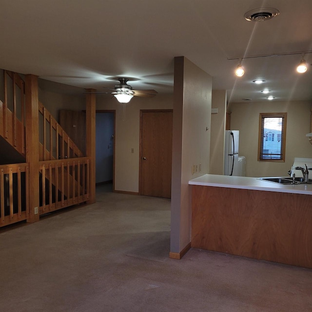 kitchen with ceiling fan, light colored carpet, sink, and white refrigerator