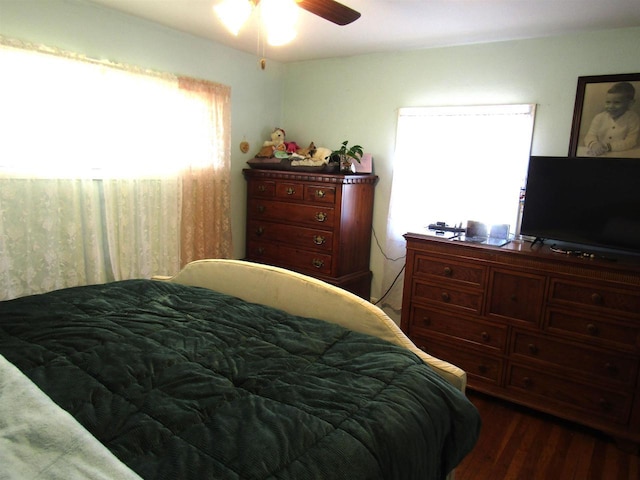 bedroom with ceiling fan and dark wood-type flooring