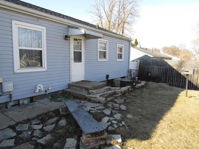 rear view of property featuring central AC