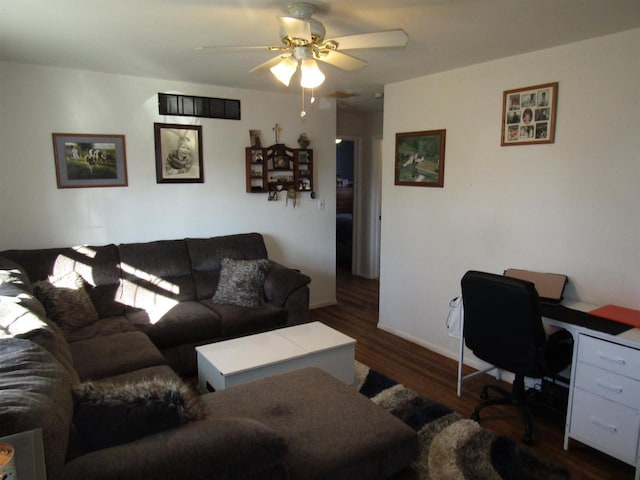 living room featuring ceiling fan and dark hardwood / wood-style floors