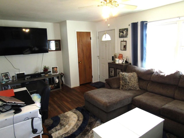 living room with dark wood-type flooring and ceiling fan