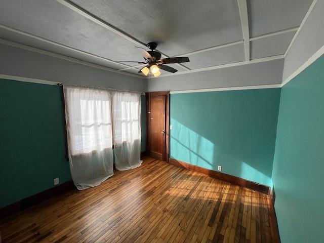 unfurnished room featuring ceiling fan and hardwood / wood-style flooring