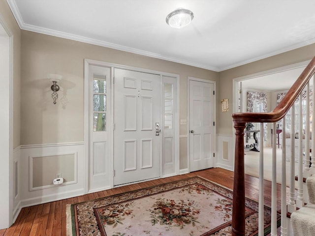 entryway with crown molding and hardwood / wood-style floors