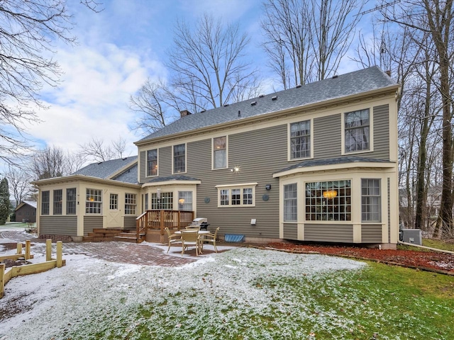 snow covered house featuring a patio