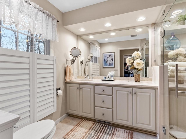 bathroom featuring toilet, an enclosed shower, and vanity