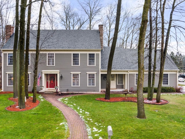 colonial home with a front lawn