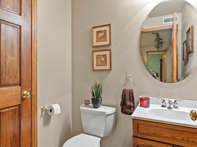 bathroom featuring toilet and vanity