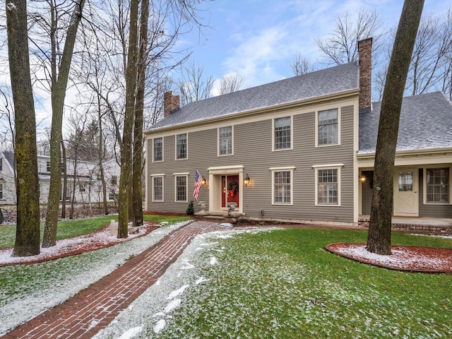 colonial-style house with a front yard