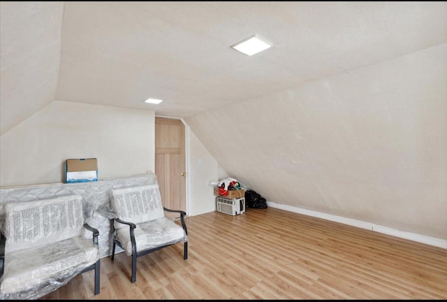 sitting room with vaulted ceiling and light hardwood / wood-style flooring