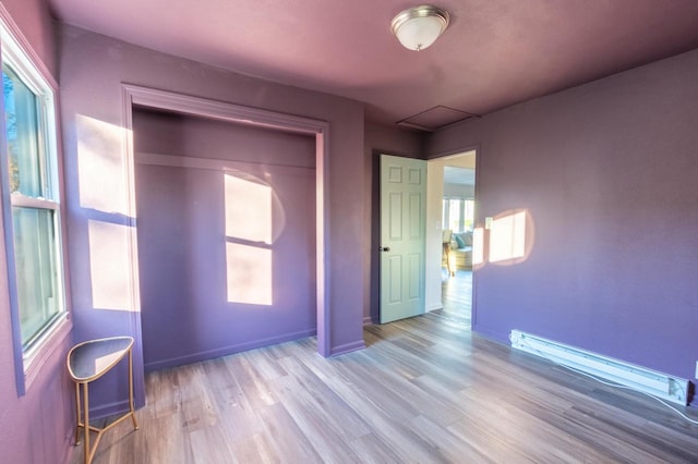 unfurnished bedroom featuring light hardwood / wood-style floors and a closet