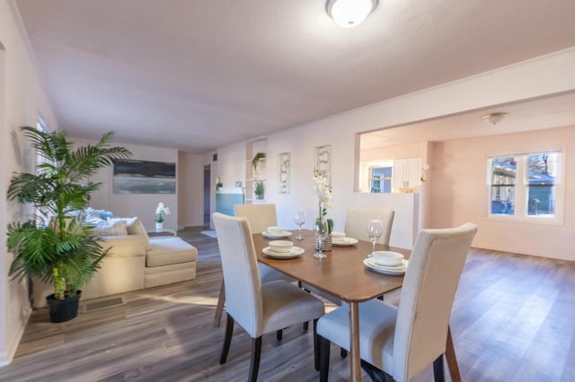 dining space featuring wood-type flooring