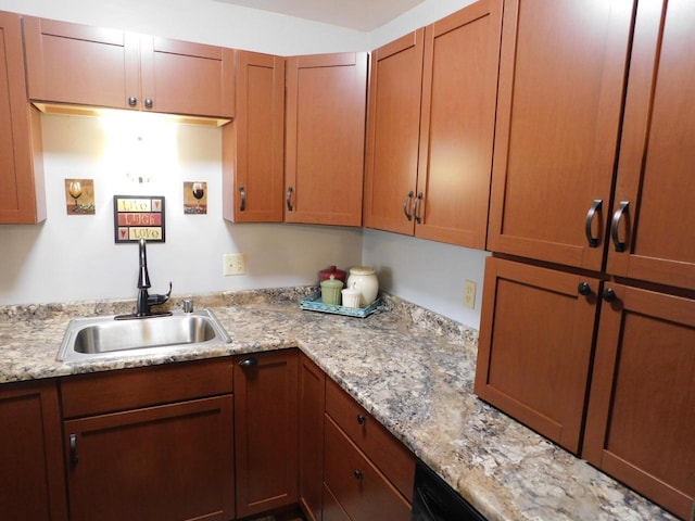 kitchen with light stone counters and sink