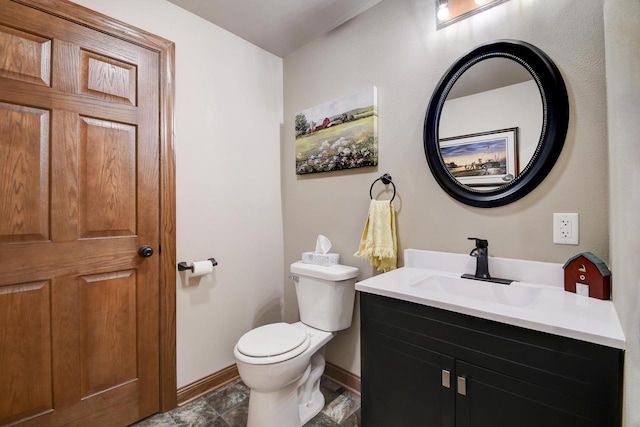 bathroom featuring toilet and vanity