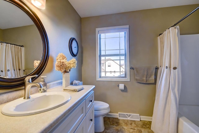 full bathroom featuring toilet, vanity, and shower / bath combo with shower curtain