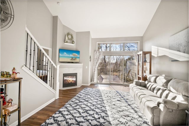 living room with high vaulted ceiling and hardwood / wood-style flooring