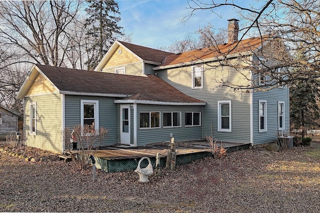 rear view of property with a wooden deck