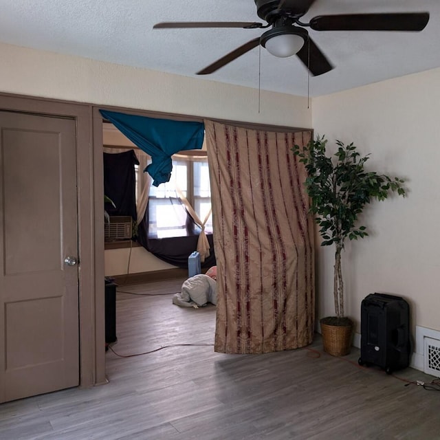 interior space featuring ceiling fan and wood-type flooring