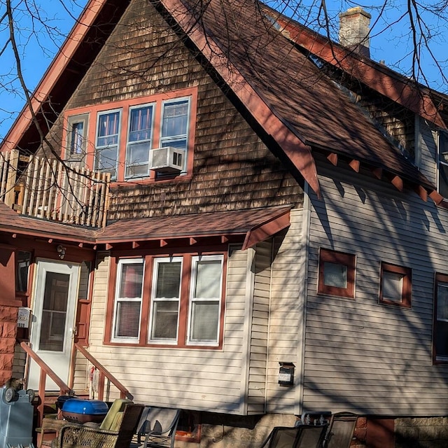 view of property exterior featuring a balcony and cooling unit