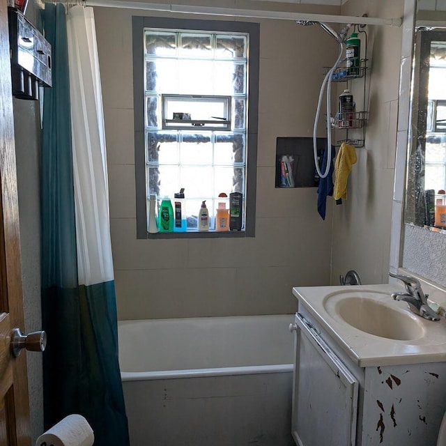 bathroom featuring vanity and shower / bath combo with shower curtain