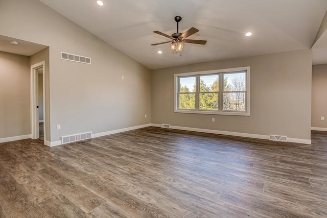 spare room with ceiling fan, vaulted ceiling, and dark wood-type flooring