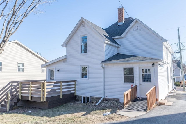 rear view of house with a wooden deck