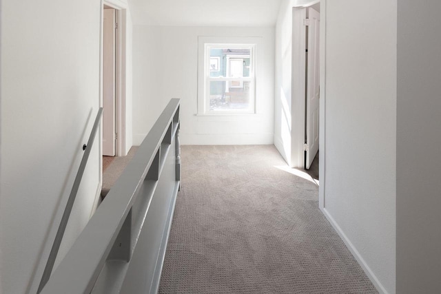 hallway featuring light colored carpet