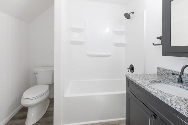 full bathroom featuring toilet, bathing tub / shower combination, hardwood / wood-style floors, and vanity