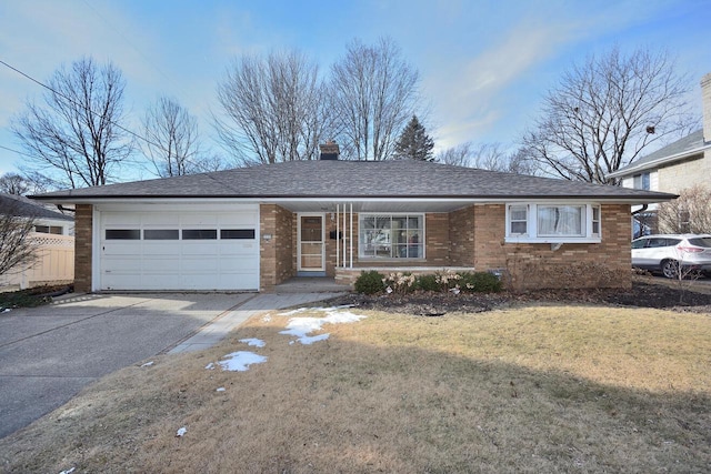 ranch-style home with a garage and a front yard