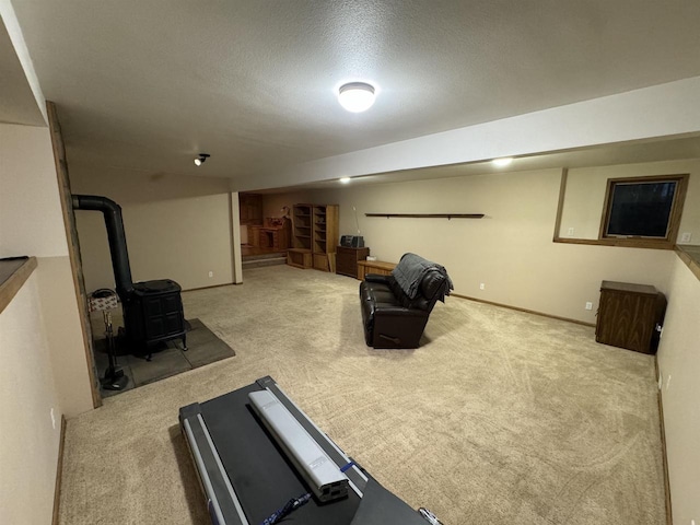 workout area featuring light colored carpet, a textured ceiling, and a wood stove