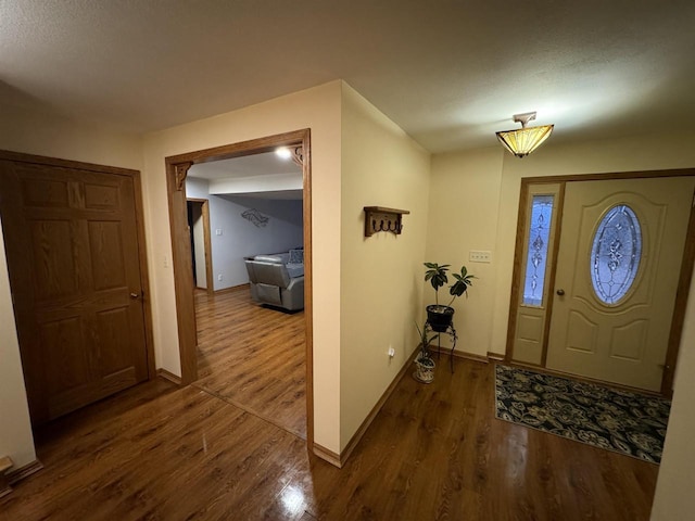 entryway with dark wood-type flooring