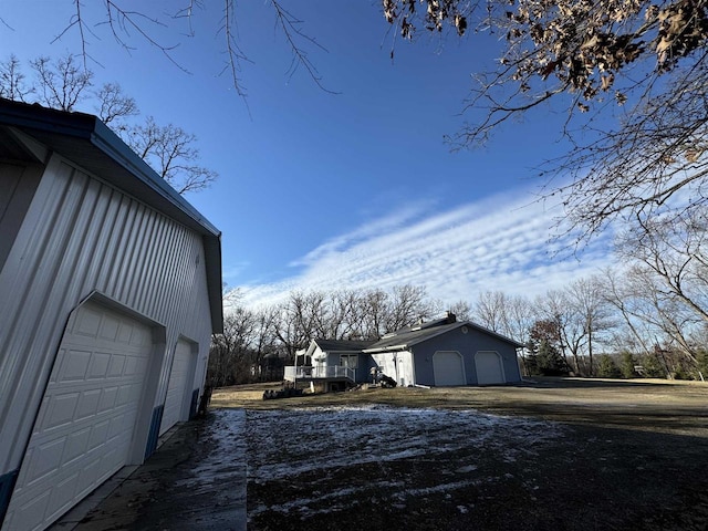 view of home's exterior with an outbuilding and a garage