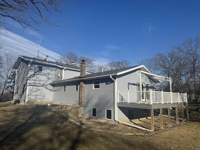 rear view of property featuring a deck