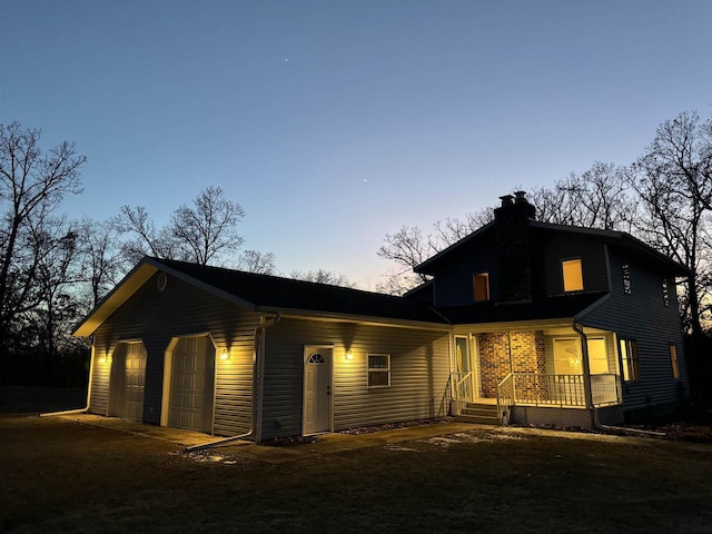 exterior space with a porch and a garage