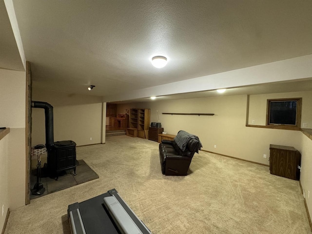 workout room with light carpet, a wood stove, and a textured ceiling