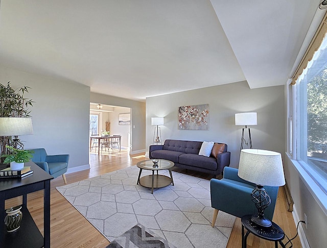 living room featuring light wood-type flooring and plenty of natural light