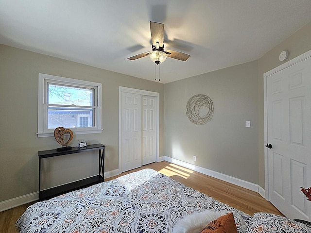 bedroom featuring ceiling fan, a closet, and light hardwood / wood-style floors