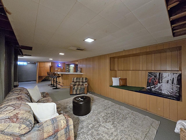 living room with bar area and wooden walls