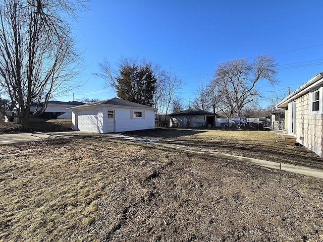 view of side of home featuring an outbuilding and a garage