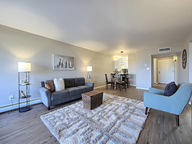 living room featuring hardwood / wood-style flooring and a baseboard heating unit