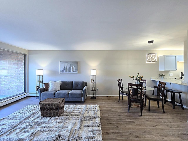 living room with sink, dark hardwood / wood-style floors, and baseboard heating